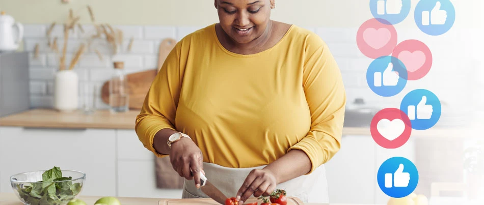 A person prepares food with a knife as emojis of hearts and thumb-ups display to their right.